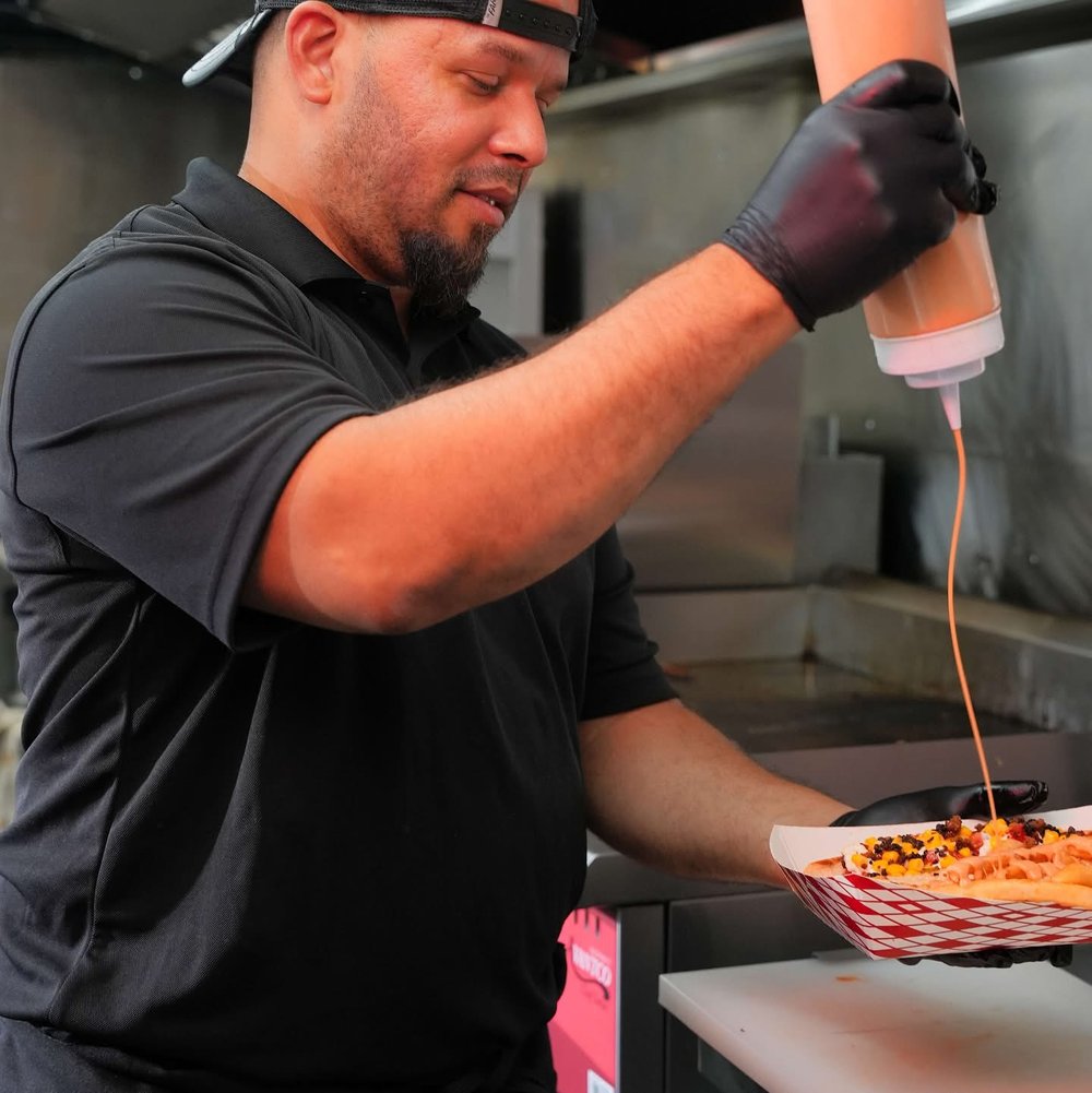 Típico Sweet & Salt owner preparing a yaroa inside the Dominican food truck in NEPA